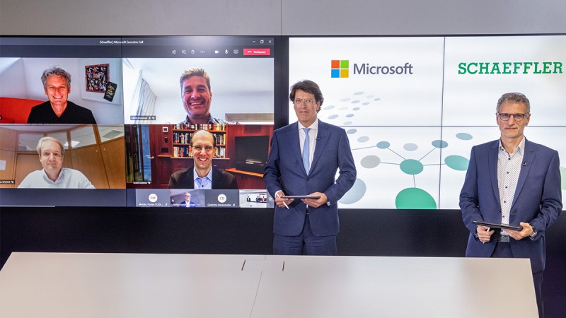 CEO of Schaeffler AG Klaus Rosenfeld (standing on the left) and Jürgen Henn, Senior Vice President Strategic Digitalization (standing on the right), with Ralph Haupter, President EMEA at Microsoft (top left on the screen), Andreas Schick, Schaeffler COO (bottom left on the screen), Ulrich Homann, Corporate Vice President at Microsoft (top right on the screen), and Scott Guthrie, Executive Vice President at Microsoft (bottom right on the screen)